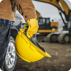 A construction worker holding his safety helmet